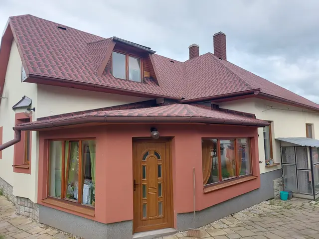 3D cserépmintás, vörösesbarna bitumenes lemezfedés egy családi házon
